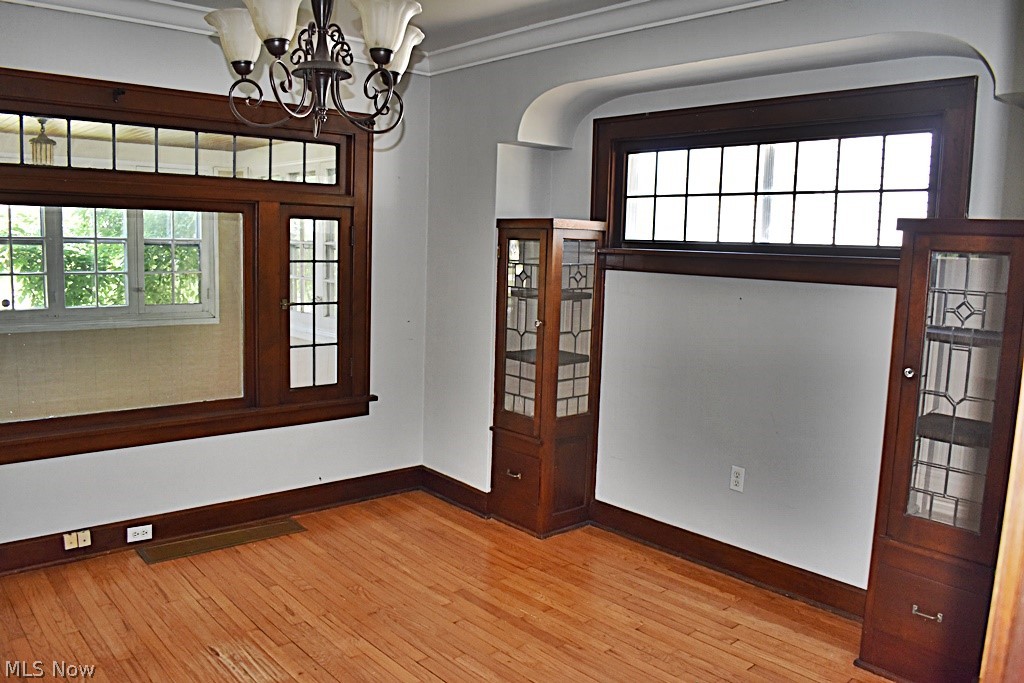7715 Ackley Road Parma, OH 44129 - Photo 6 of 27 Dining room with a chandelier, ornamental molding, and hardwood flooring