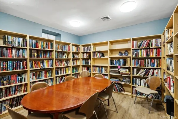 a view of a livingroom with furniture and a bookshelf