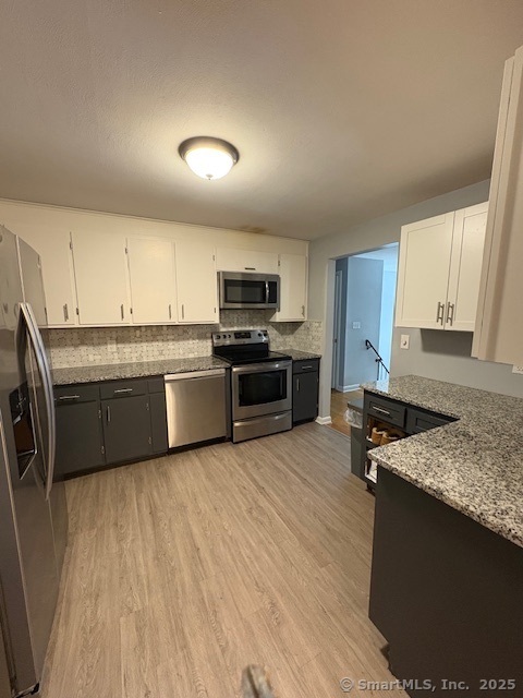 26 Lamphere Road Waterford, CT 06385 - Photo 3 of 14 a kitchen with stainless steel appliances granite countertop a stove a sink and a refrigerator