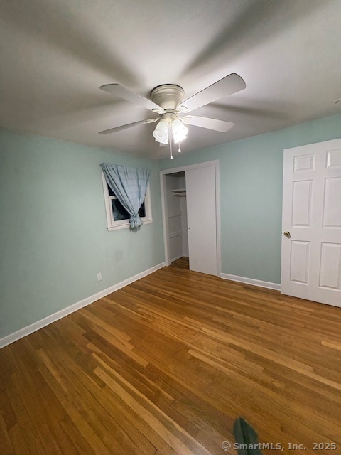 26 Lamphere Road Waterford, CT 06385 - Photo 9 of 14 a view of a big room with wooden floor a ceiling fan and closet