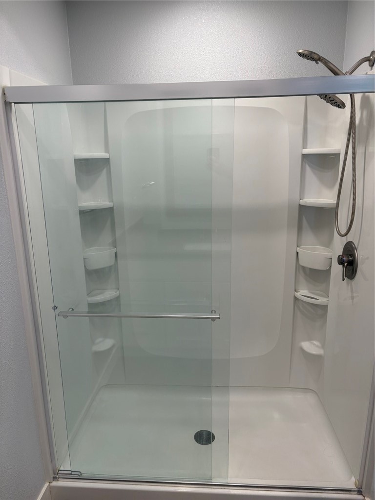 7 Rainbow, Unit 4 Irvine, CA 92603 - Photo 15 of 31 a bathroom with a glass shower door