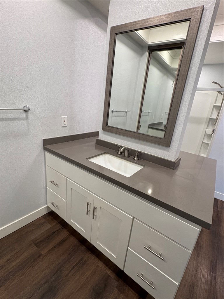 7 Rainbow, Unit 4 Irvine, CA 92603 - Photo 17 of 31 a bathroom with a granite countertop sink and a mirror