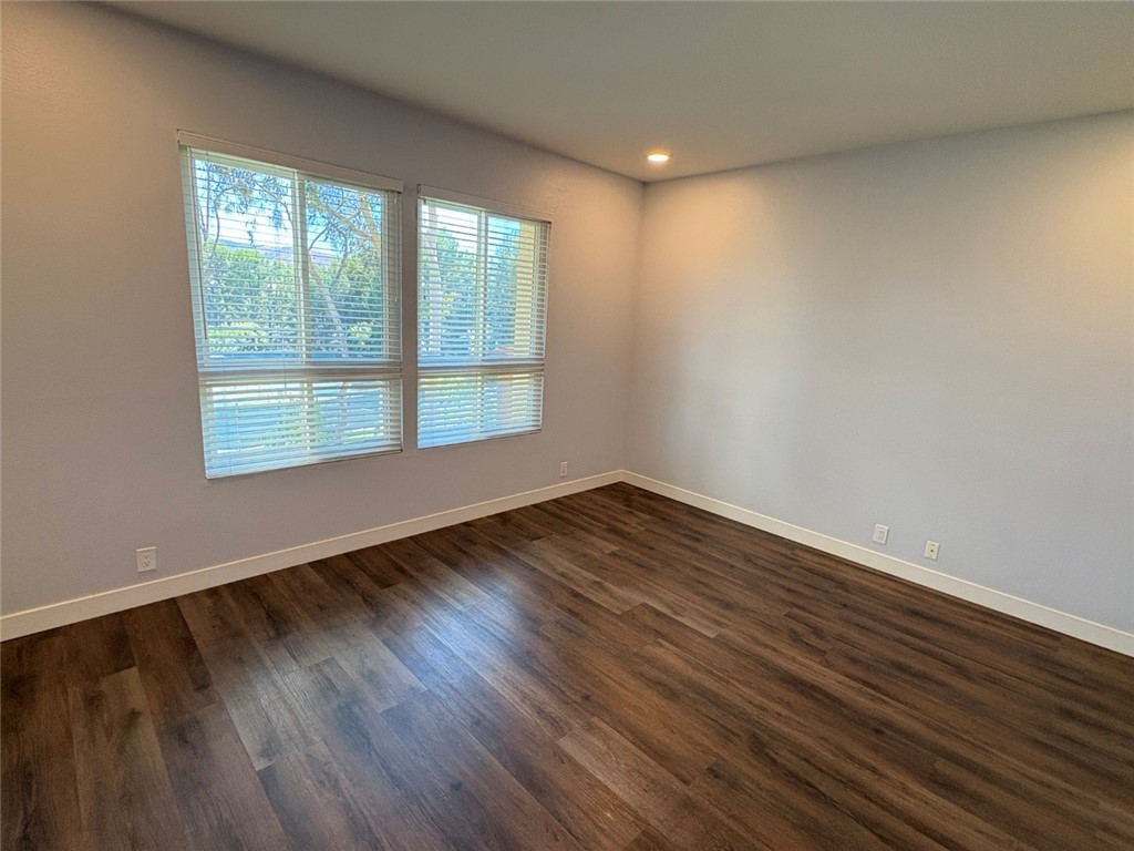 7 Rainbow, Unit 4 Irvine, CA 92603 - Photo 20 of 31 a view of an empty room with wooden floor and a window