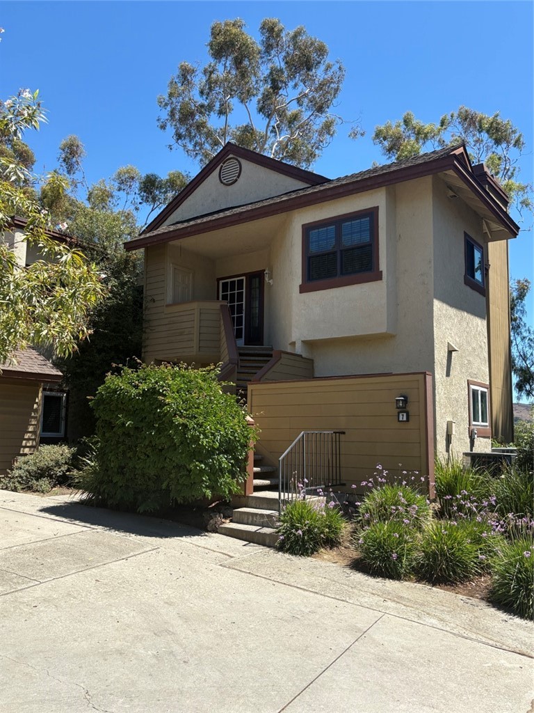 7 Rainbow, Unit 4 Irvine, CA 92603 - Photo 2 of 31 a front view of a house with a yard