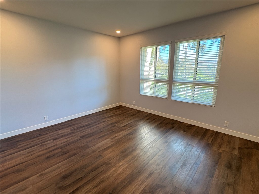 7 Rainbow, Unit 4 Irvine, CA 92603 - Photo 22 of 31 a view of an empty room with wooden floor and window