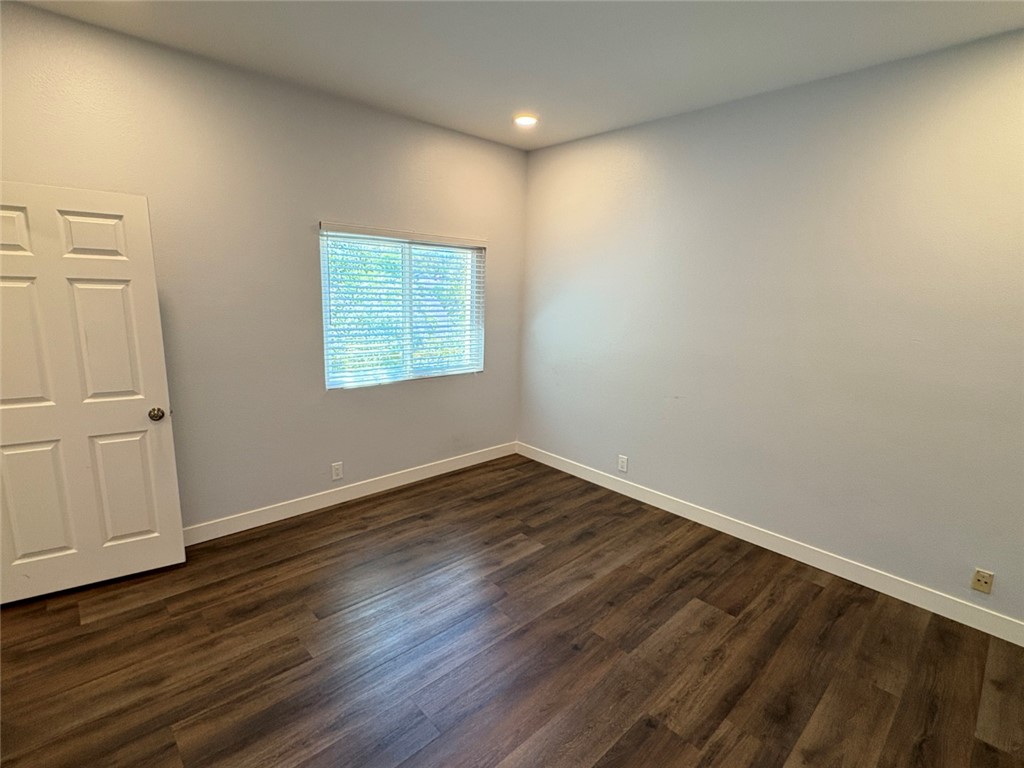 7 Rainbow, Unit 4 Irvine, CA 92603 - Photo 25 of 31 a view of an empty room with wooden floor and a window