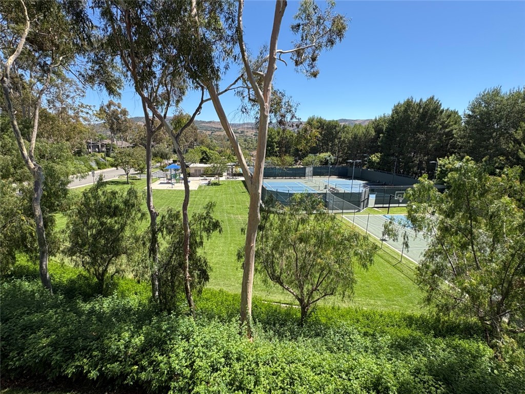 7 Rainbow, Unit 4 Irvine, CA 92603 - Photo 26 of 31 a backyard of a house with lots of green space