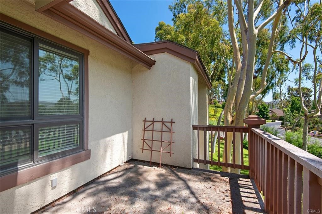 7 Rainbow, Unit 4 Irvine, CA 92603 - Photo 27 of 31 a view of a house with a large window and wooden fence