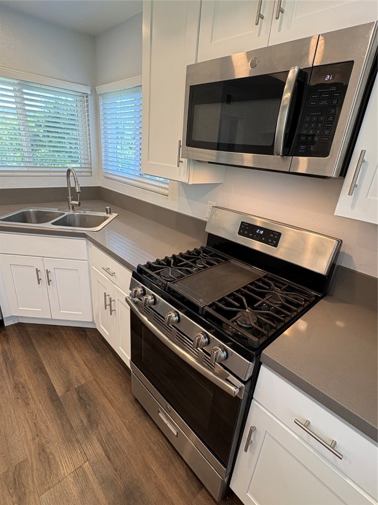 7 Rainbow, Unit 4 Irvine, CA 92603 - Photo 5 of 31 a kitchen with a stove and a microwave