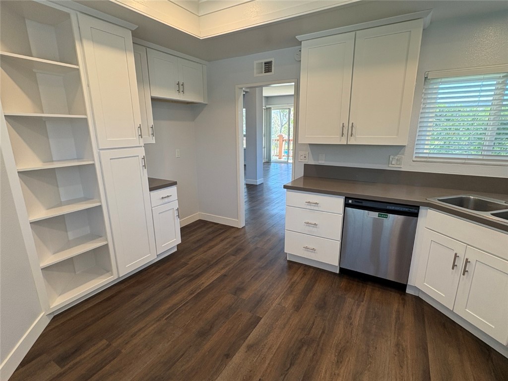 7 Rainbow, Unit 4 Irvine, CA 92603 - Photo 6 of 31 a kitchen with stainless steel appliances white cabinets and wooden floor