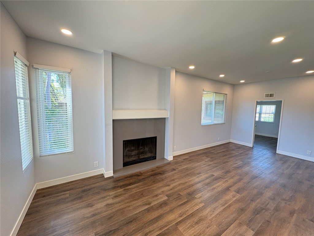 7 Rainbow, Unit 4 Irvine, CA 92603 - Photo 7 of 31 a view of an empty room with wooden floor and a window