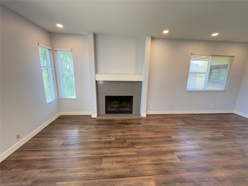 7 Rainbow, Unit 4 Irvine, CA 92603 - Photo 8 of 31 a view of an empty room with wooden floor fireplace and a window