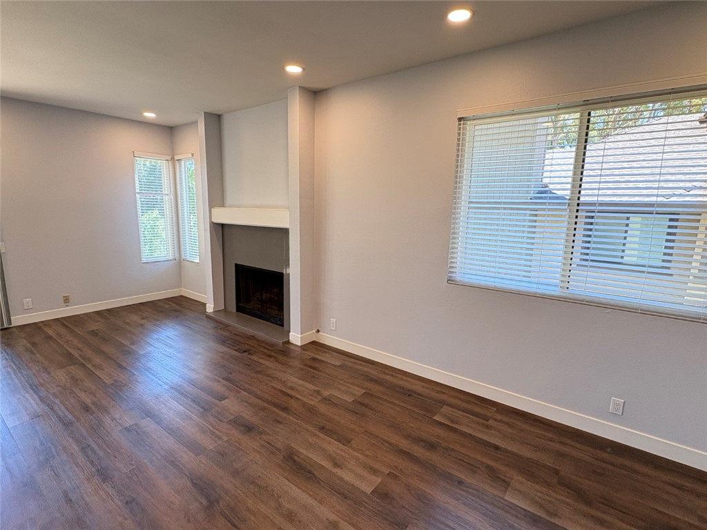 7 Rainbow, Unit 4 Irvine, CA 92603 - Photo 9 of 31 a view of an empty room with wooden floor and a window