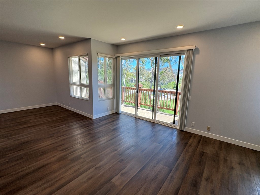 7 Rainbow, Unit 4 Irvine, CA 92603 - Photo 10 of 31 a view of an empty room with wooden floor and a window