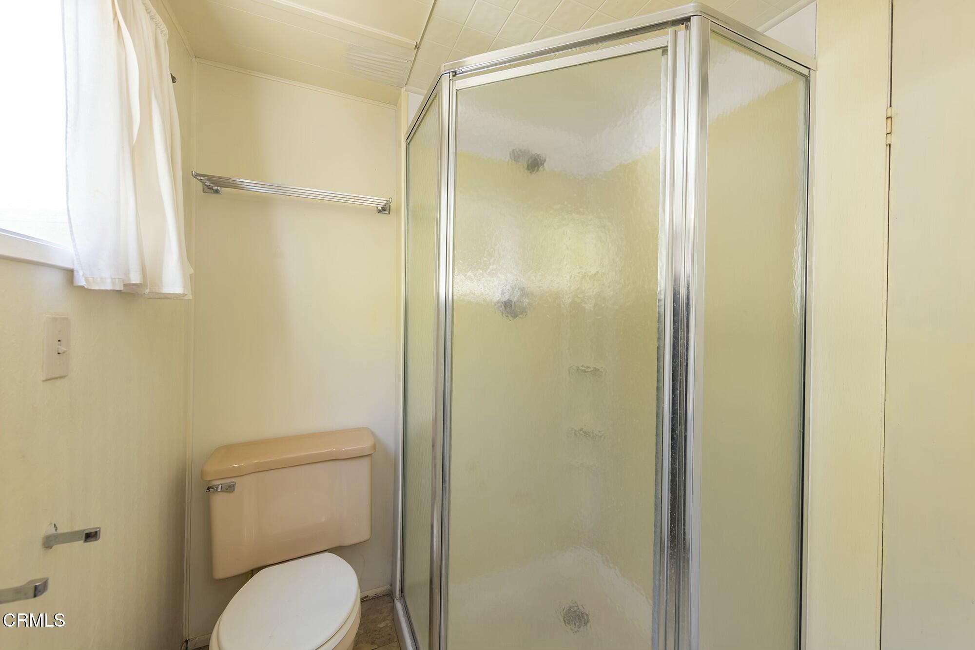 1225 South Rice Road, Unit 6 Ojai, CA 93023 - Photo 16 of 21 a bathroom that has a glass shower door