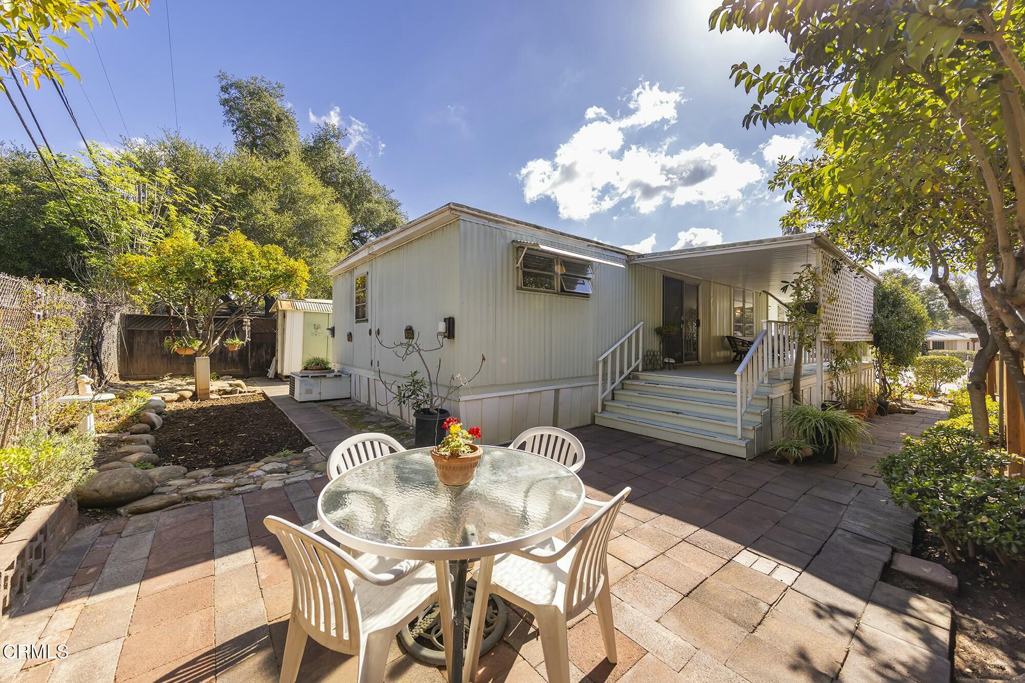1225 South Rice Road, Unit 6 Ojai, CA 93023 - Photo 3 of 21 a view of a patio with table and chairs with a barbeque grill and potted plants
