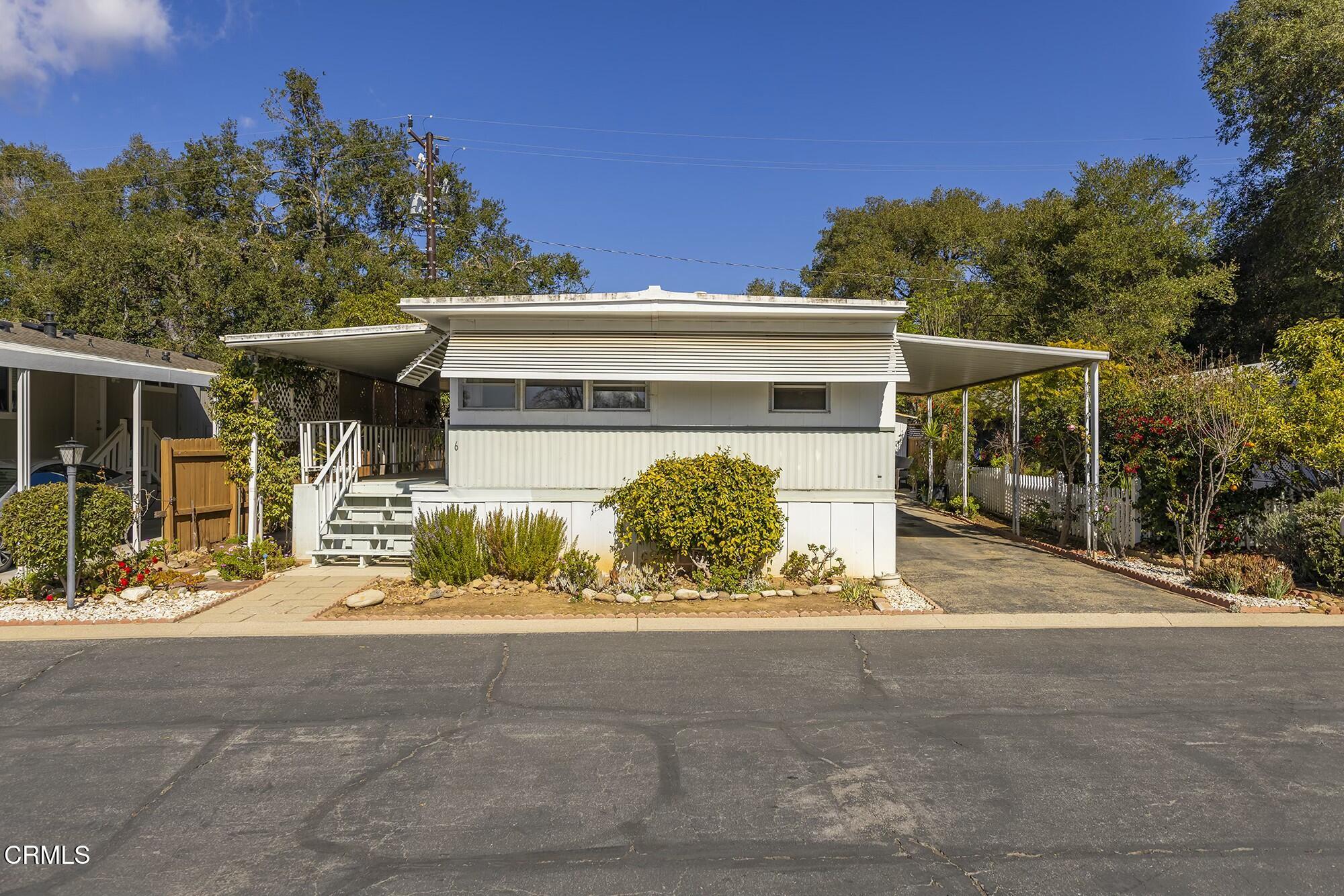 1225 South Rice Road, Unit 6 Ojai, CA 93023 - Photo 4 of 21 a front view of a house with a yard and garage