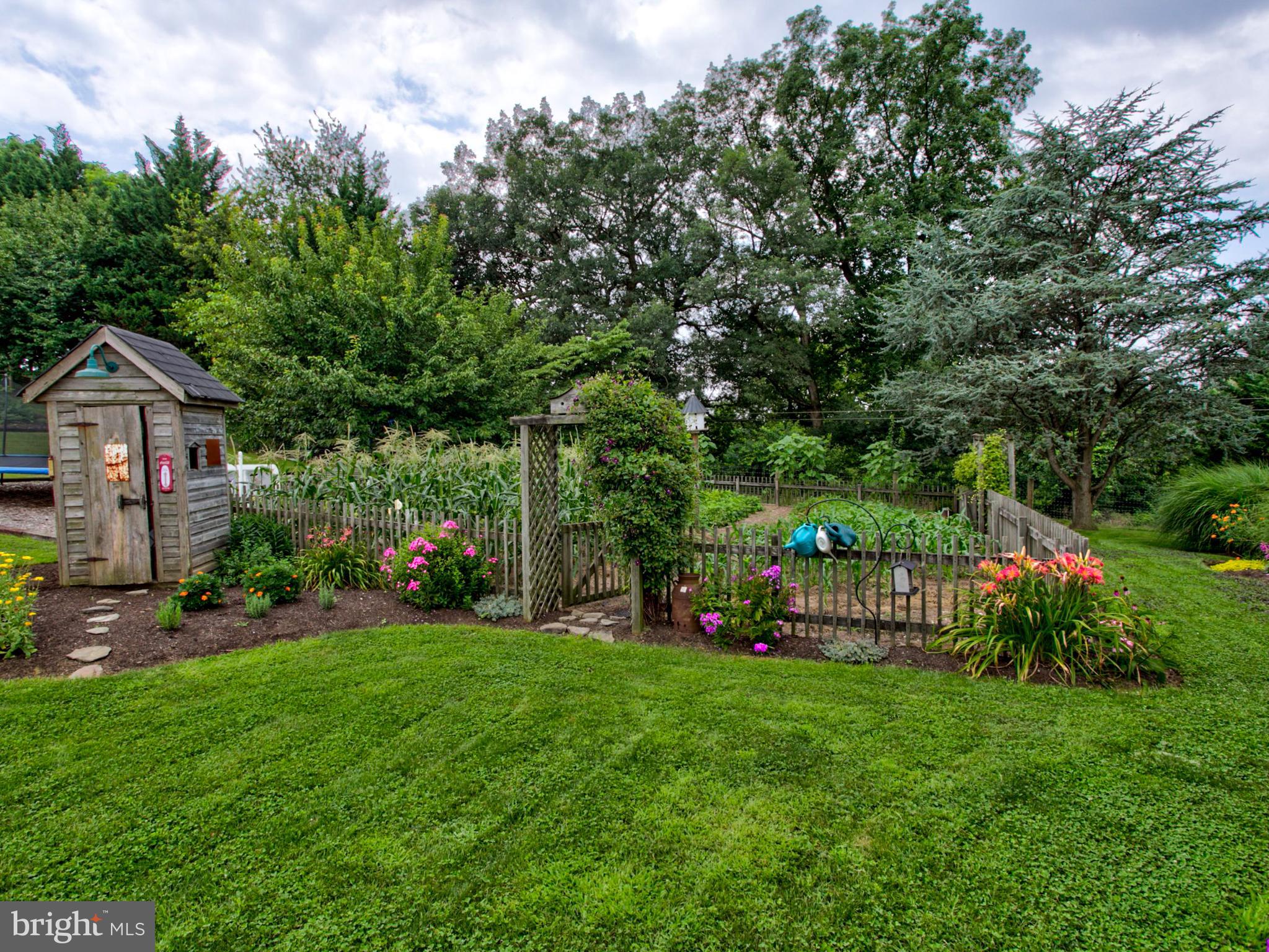 8486 Elizabethtown Road Elizabethtown, PA 17022 - Photo 25 of 58 a front view of a house with garden