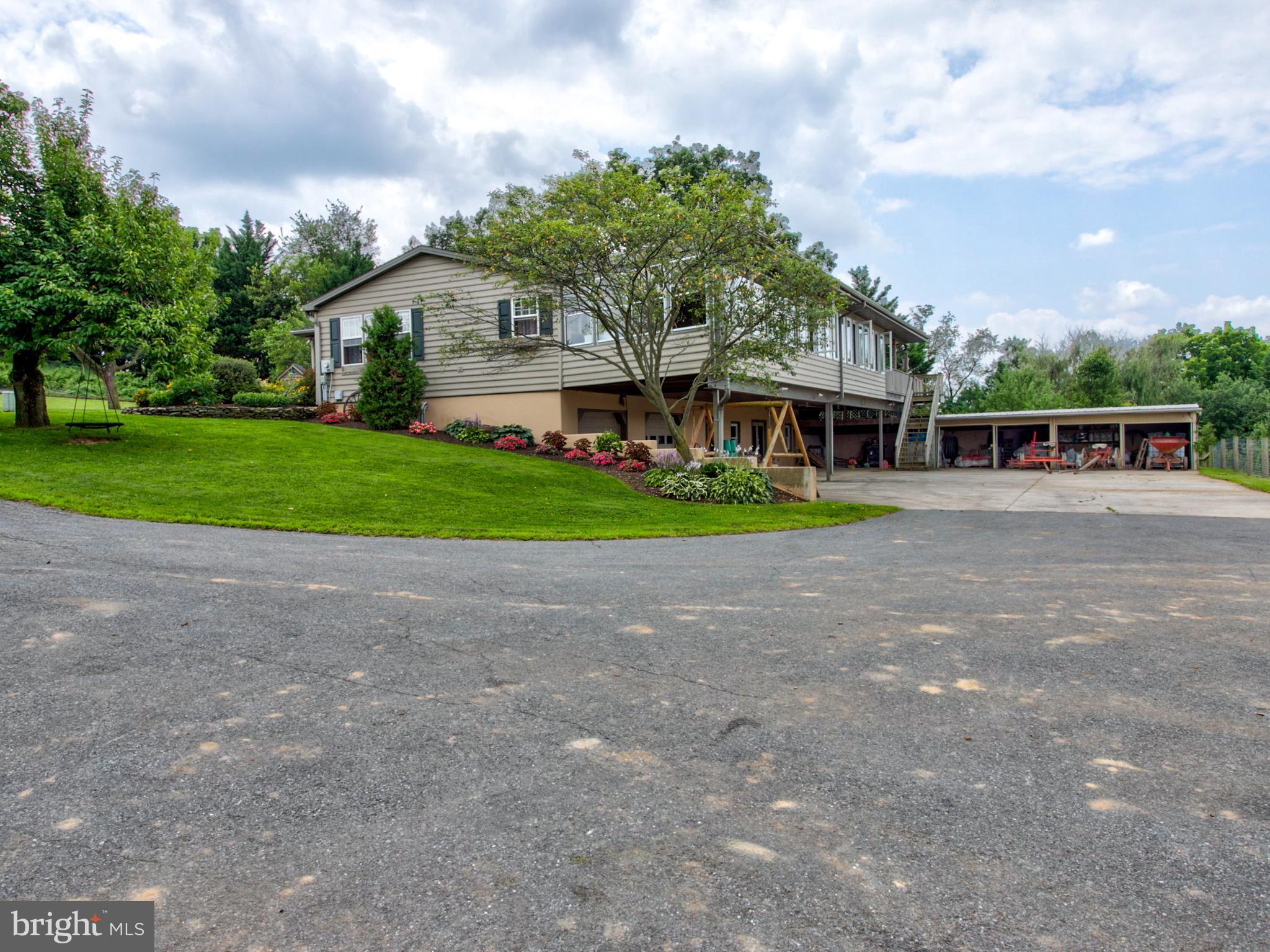 8486 Elizabethtown Road Elizabethtown, PA 17022 - Photo 32 of 58 a front view of a house with a yard and potted plants
