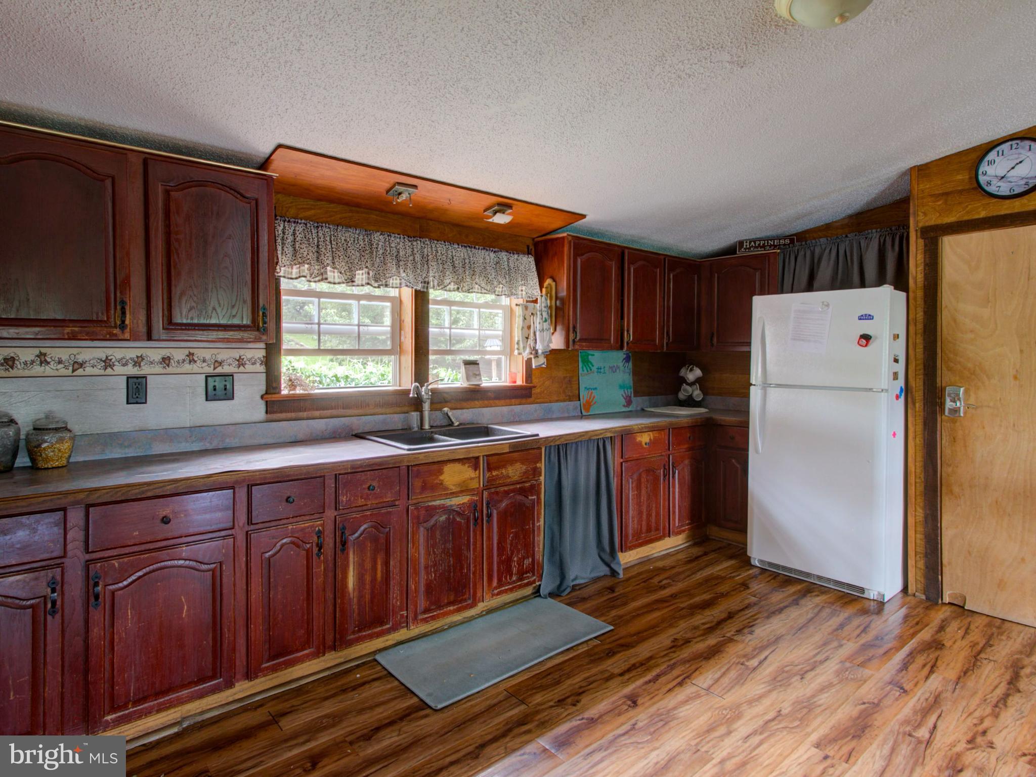 8486 Elizabethtown Road Elizabethtown, PA 17022 - Photo 50 of 58 a kitchen with wooden floors and wooden cabinets