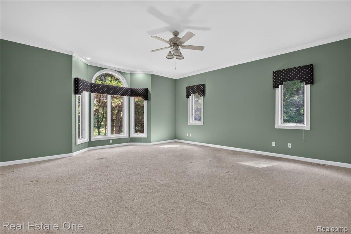 425 Courtney Road Leonard, MI 48367 - Photo 41 of 89 Spacious room with plush carpeting and a neutral green wall finish