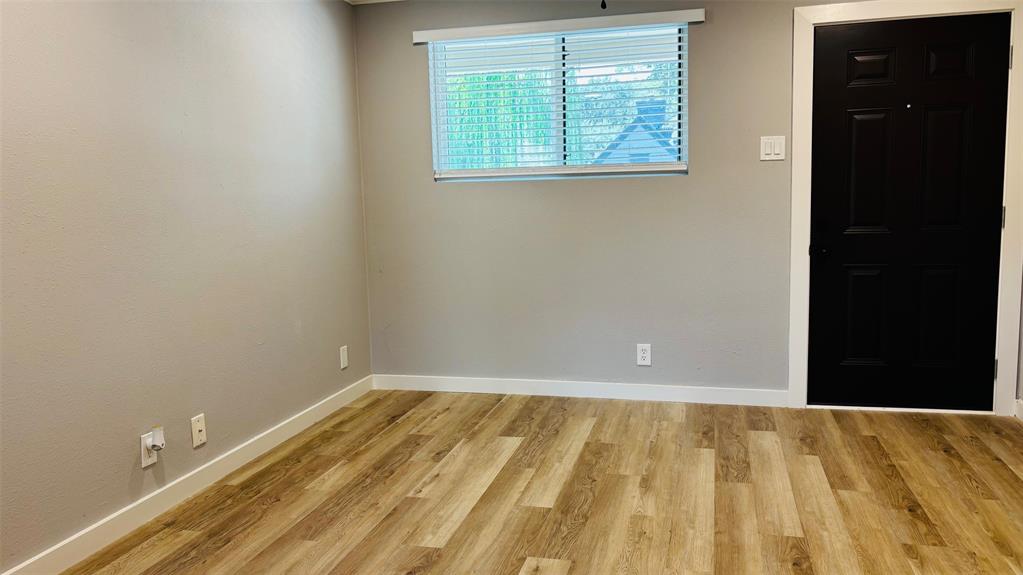 4603 Junius Street, Unit 6 Dallas, TX 75246 - Photo 2 of 12 Living room featuring light wood-type flooring and baseboards