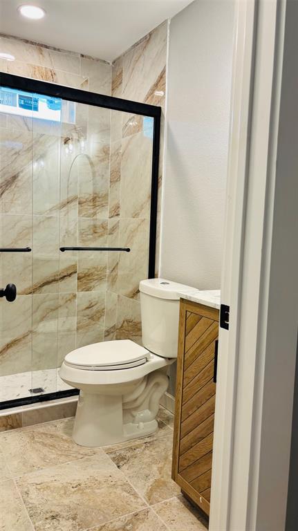 4603 Junius Street, Unit 6 Dallas, TX 75246 - Photo 7 of 12 Full bathroom featuring a marble finish shower and vanity