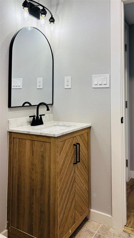 4603 Junius Street, Unit 6 Dallas, TX 75246 - Photo 8 of 12 Bathroom with vanity and a textured wall
