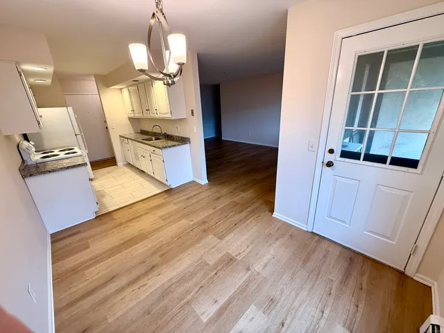 a view of a kitchen cabinets and wooden floor