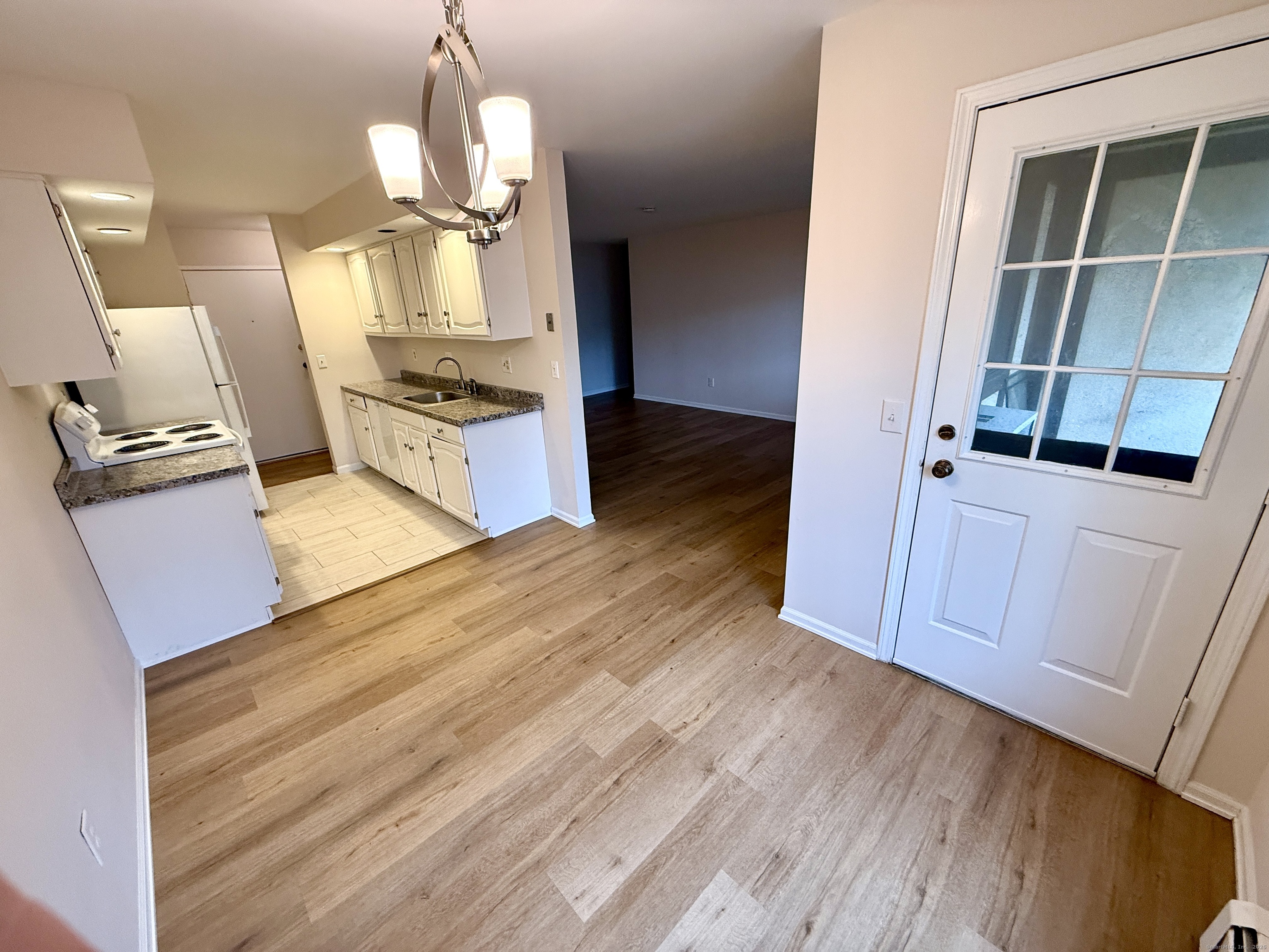 17 Rollingwood Drive, Unit 17 Brookfield, CT 06804 - Photo 6 of 13 a view of a kitchen cabinets and wooden floor