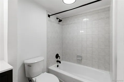 a bathroom with a toilet and shower