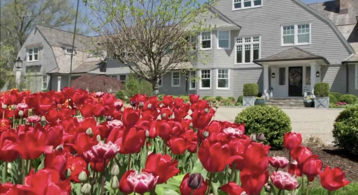 507 Smith Ridge Road New Canaan, CT 06840 - Photo 3 of 16 a front view of a house with yard and fountain in front of it