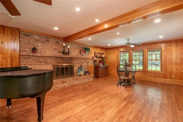 a view of a workspace with furniture and wooden floor