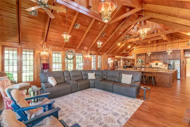 a view of a room with wooden floor and furniture
