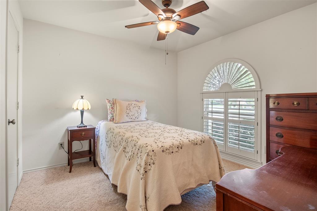 1104 Timberbend Trail Allen, TX 75002 - Photo 21 of 32 a bedroom with a bed and a window