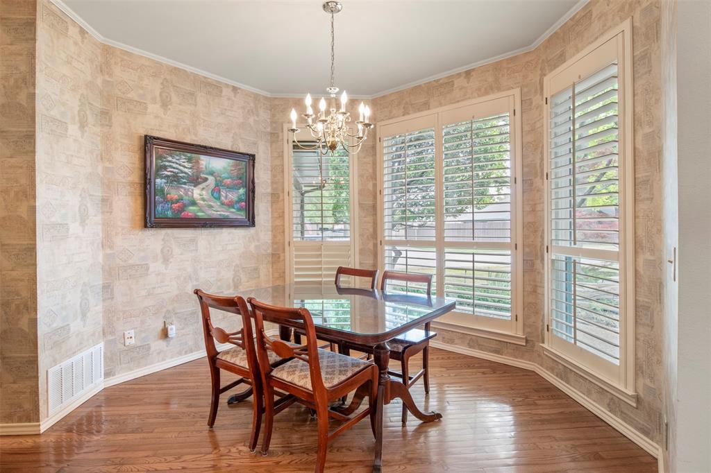 1104 Timberbend Trail Allen, TX 75002 - Photo 6 of 32 a dining room with furniture a chandelier and wooden floor
