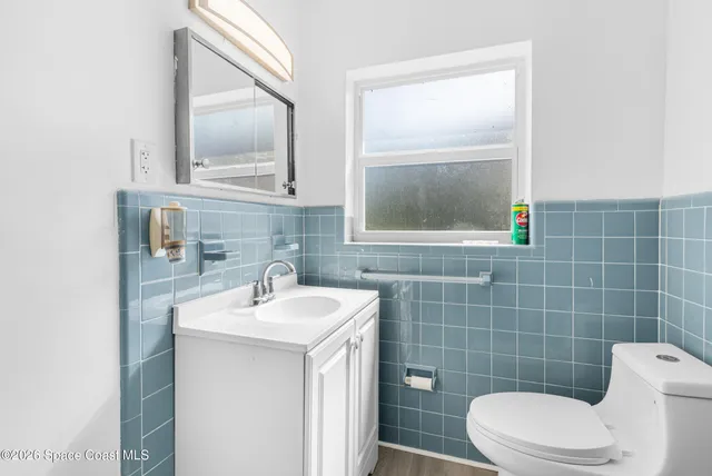 a bathroom with a sink a toilet and mirror