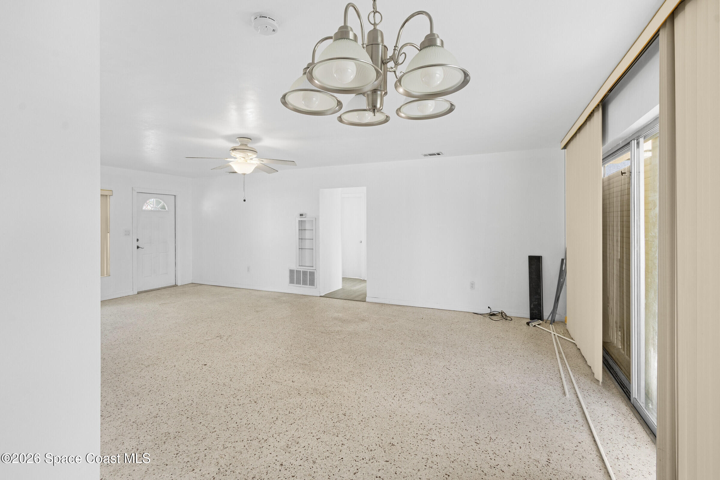 407 Bunker Street Melbourne, FL 32901 - Photo 8 of 20 a view of an empty room and a chandelier