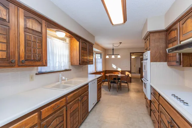 a view of a livingroom with a chandelier fan and a bathroom