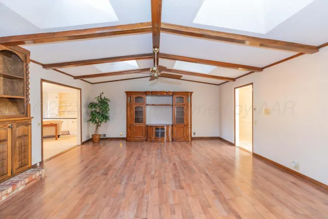 a view of a bedroom with cabinet and windows