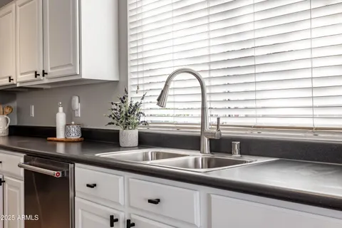 a kitchen with stainless steel appliances kitchen island granite countertop a stove a sink and a refrigerator