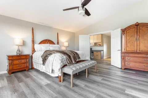 a spacious bedroom with a large bed and a dresser