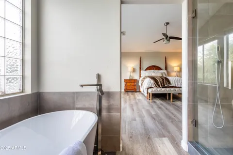 a bathroom with a bathtub a sink and a window