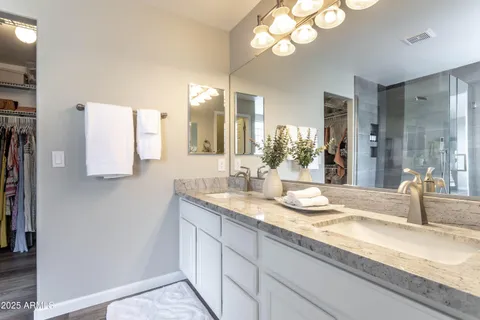 a walk in closet with a mirror