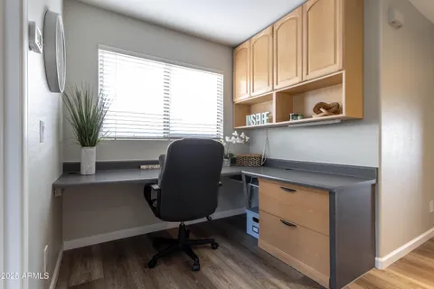a view of a livingroom with wooden floor and furniture