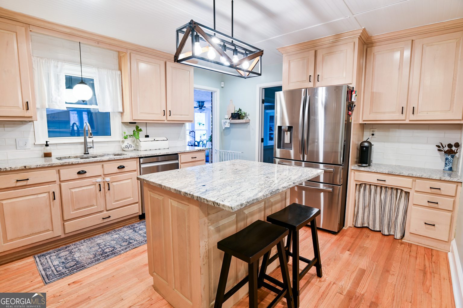 93 Deerfield Road Covington, GA 30014 - Photo 16 of 78 a kitchen with stainless steel appliances granite countertop a kitchen island hardwood floor and a sink