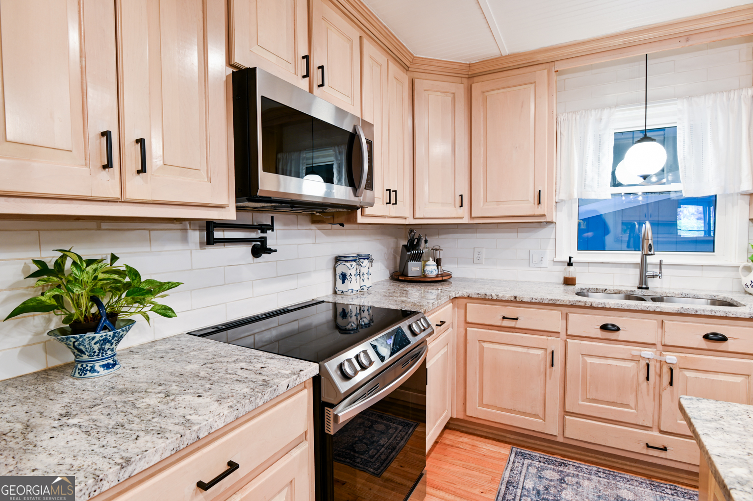 93 Deerfield Road Covington, GA 30014 - Photo 21 of 78 a kitchen with a sink a microwave and cabinets