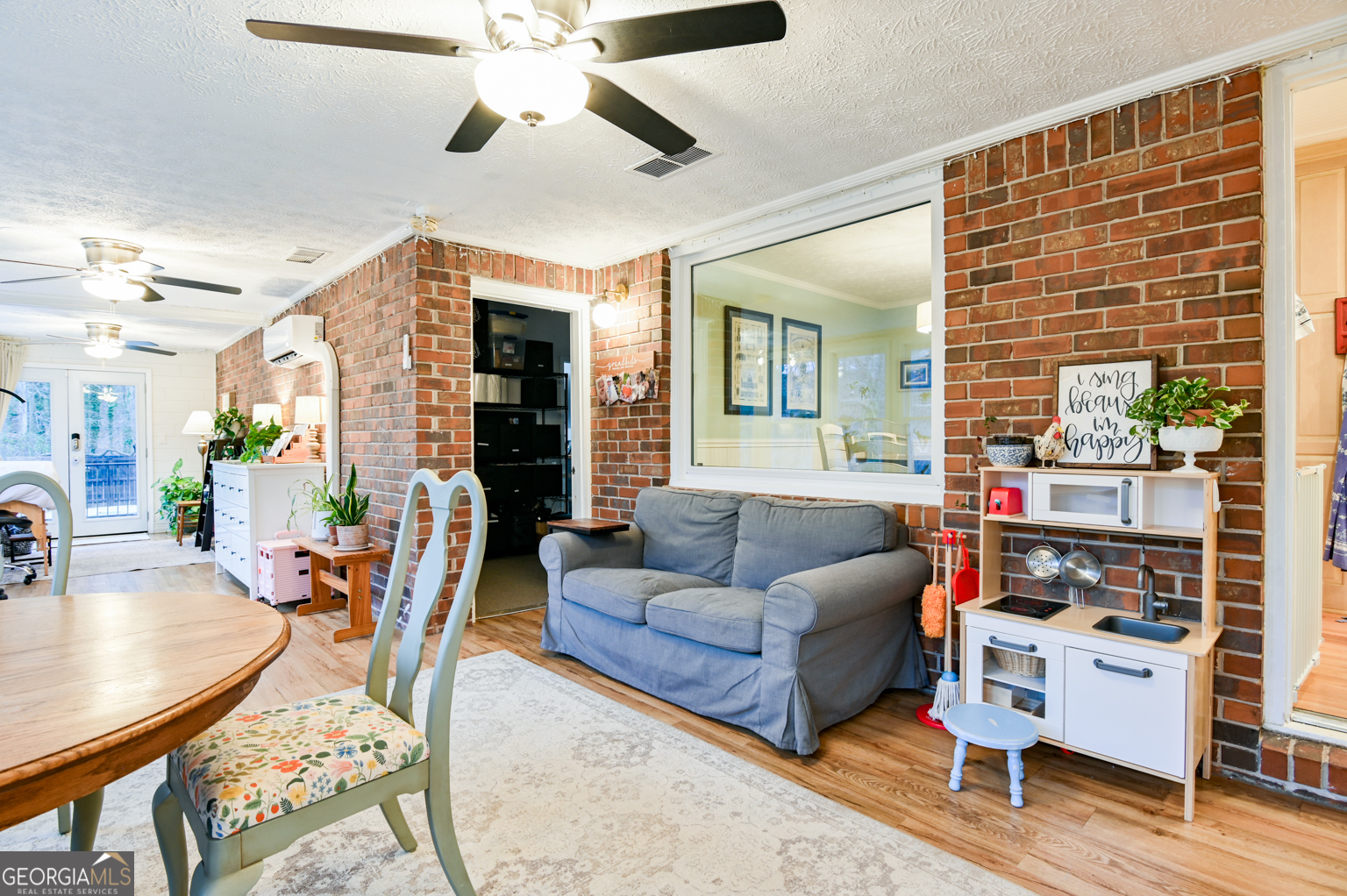 93 Deerfield Road Covington, GA 30014 - Photo 23 of 78 a living room with furniture and wooden floor