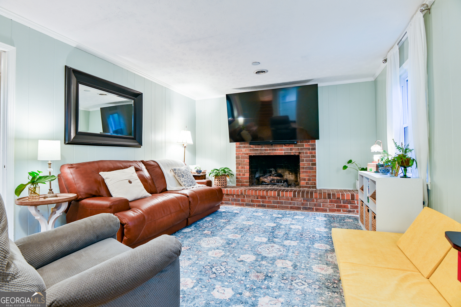 93 Deerfield Road Covington, GA 30014 - Photo 44 of 78 a living room with furniture a flat screen tv and a fireplace