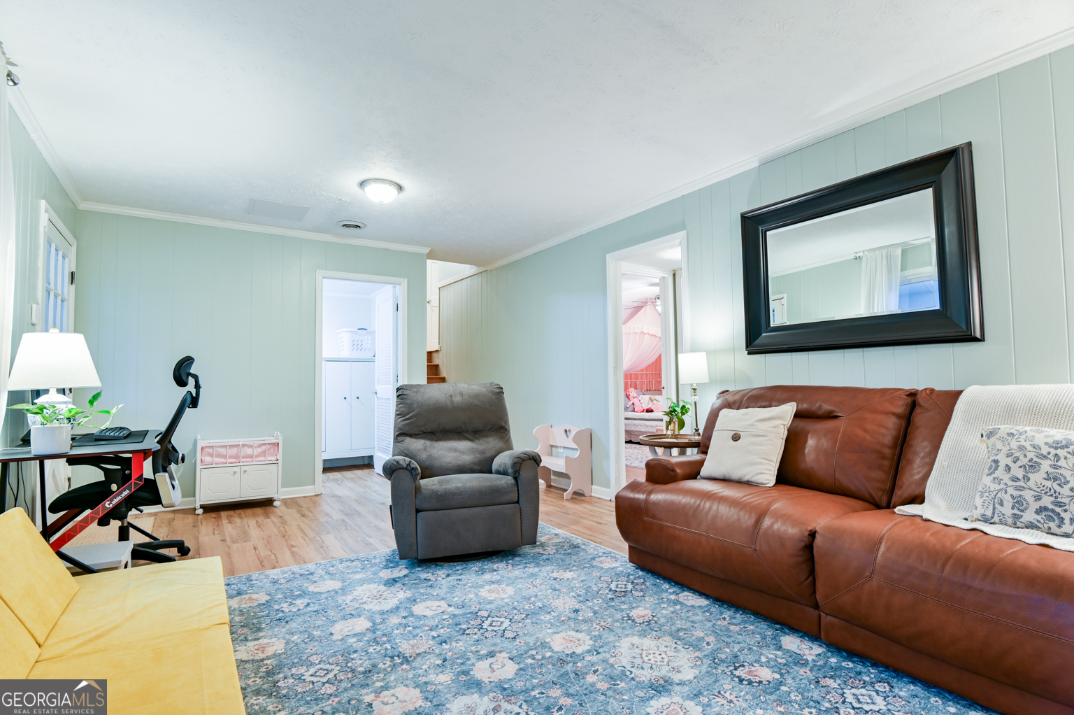 93 Deerfield Road Covington, GA 30014 - Photo 45 of 78 a living room with furniture a rug and a flat screen tv